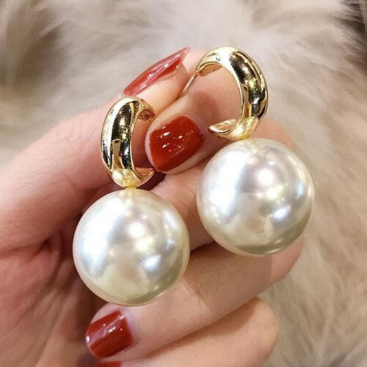 Pendientes grandes de perlas doradas
